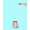 rose wine being poured into pink metallic stainless steel wine cup