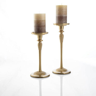 Two Clinq brass candlesticks with pillar candle