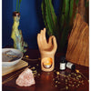 hand oil burner with essential oils on nightstand