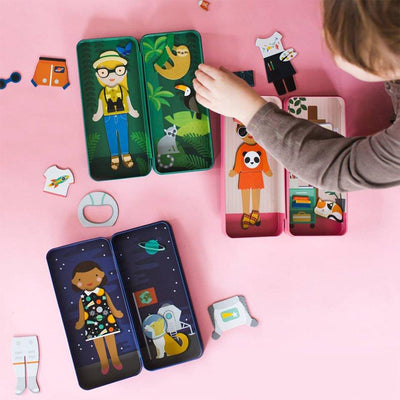 little girl playing with magnetic dress up sets
