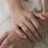 mini pearl ring on womans hand
